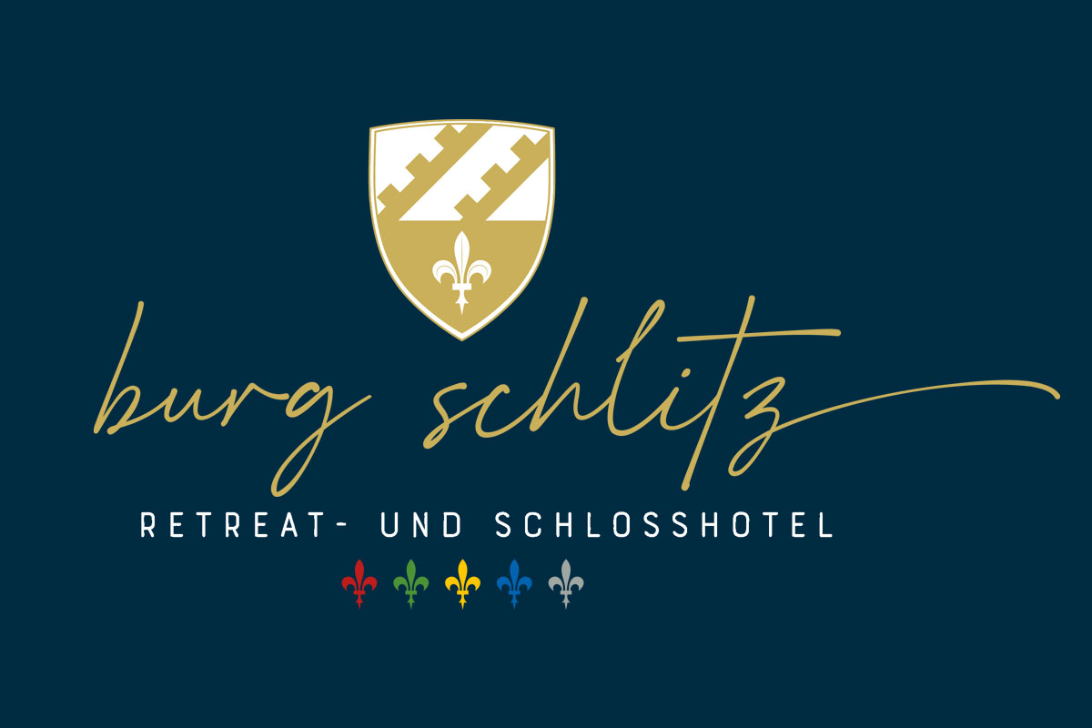 Goldenes Wappen mit weißer Lilie über dem Schriftzug